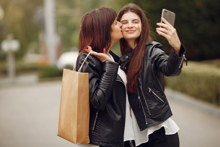 Mother with adult daughter with shopping bag in a city