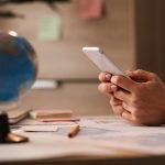 close up of businesswoman text messaging on mobile phone in the office.
