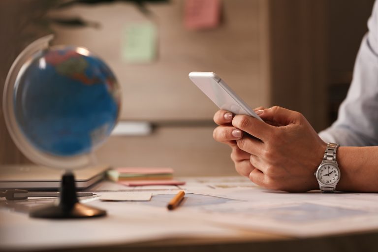 close up of businesswoman text messaging on mobile phone in the office.
